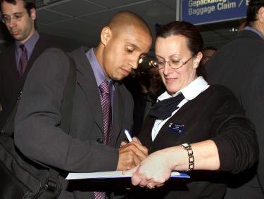 Signing an autograph to a fan